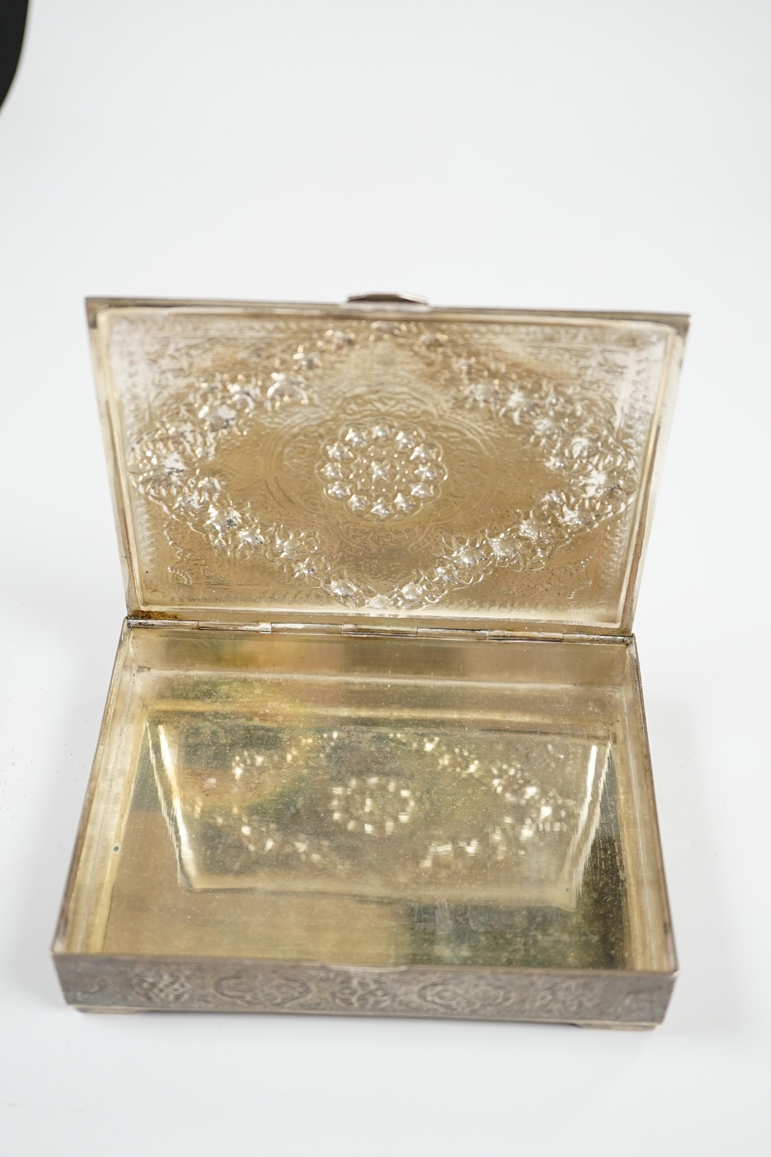 A Persian embossed white metal rectangular cigarette box, on small bracket feet, 12.2cm, 8.6oz. Condition - fair